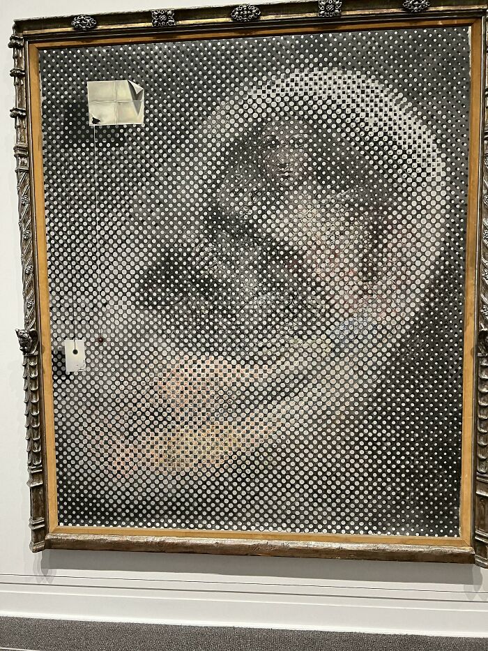 Black and white dotted art piece resembling classical painting in museum