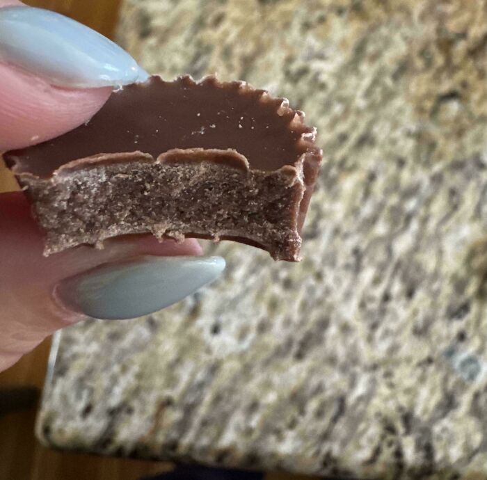 Bitten Reese's cup showing unexpected textured filling inside