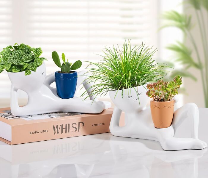 Two whimsical white human-shaped planters with plants, a hilarious Mother's Day gift for moms who love humor.