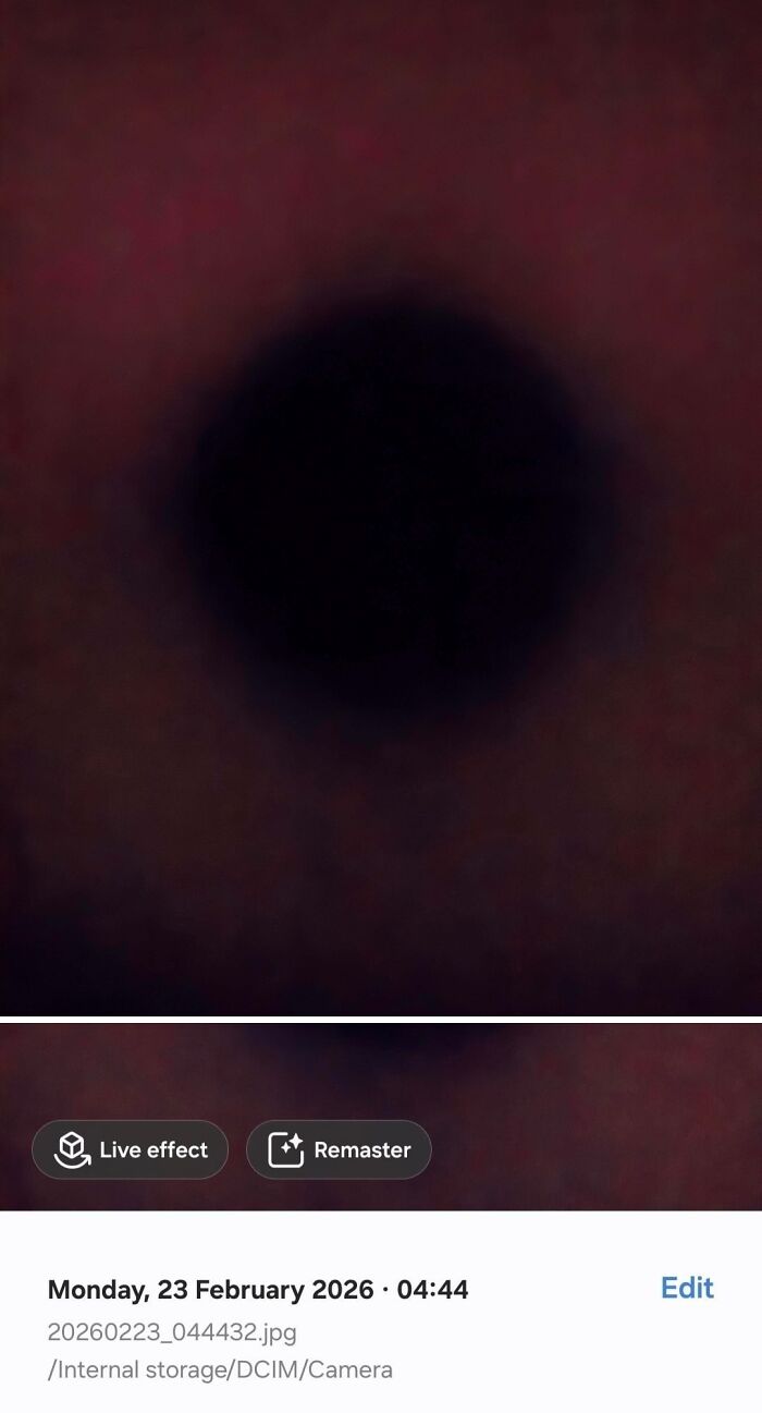 Dark circular spot on reddish surface from mobile camera