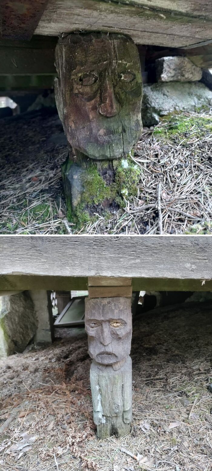 Wooden carved statues with human faces supporting structure outdoors