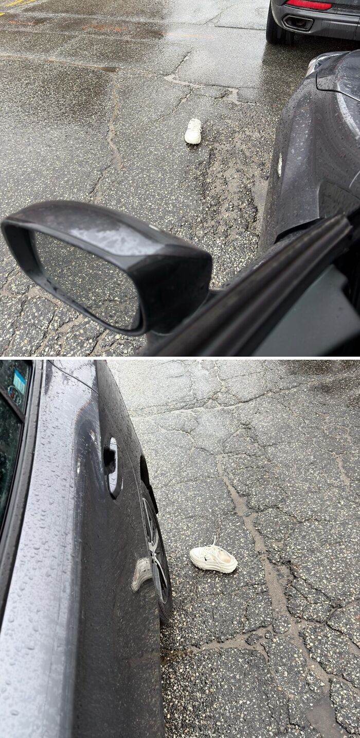 Single white sneaker stuck in cracked pavement next to parked cars