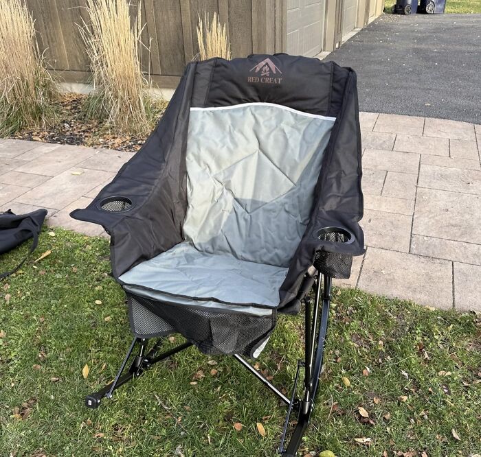 A black and grey folding rocking chair, a great last minute Mother's Day gift, on green grass.
