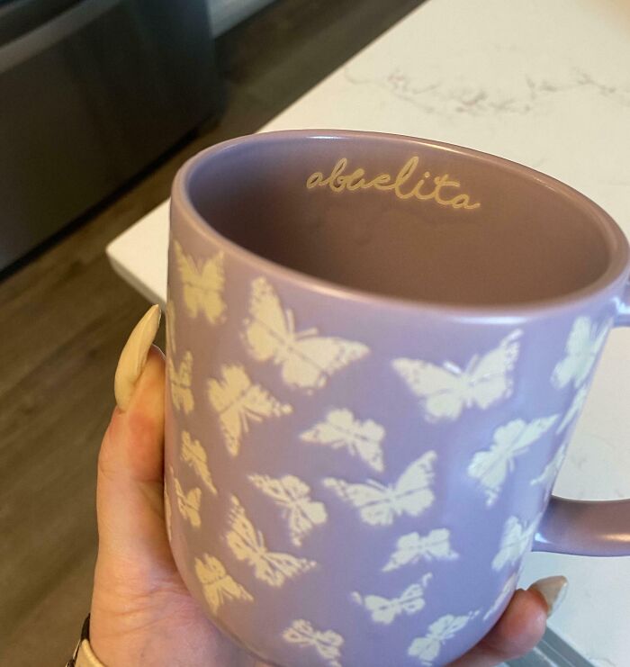 Purple mug with butterfly design and the word abuelita inside