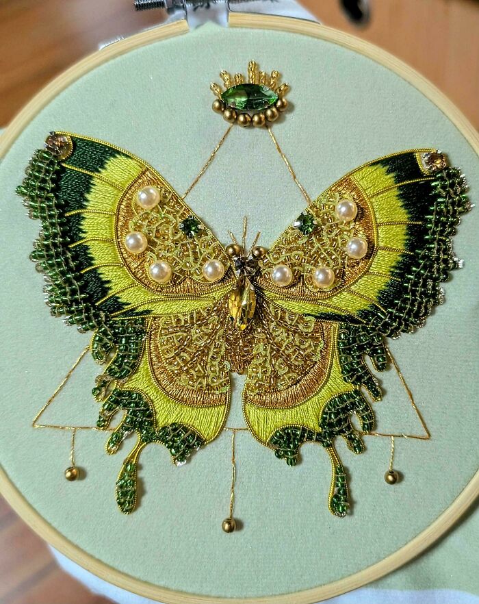 Intricate embroidery projects showcasing a beautiful butterfly adorned with beads and pearls