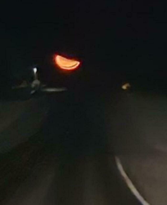 Strange crescent shaped red light in dark night sky