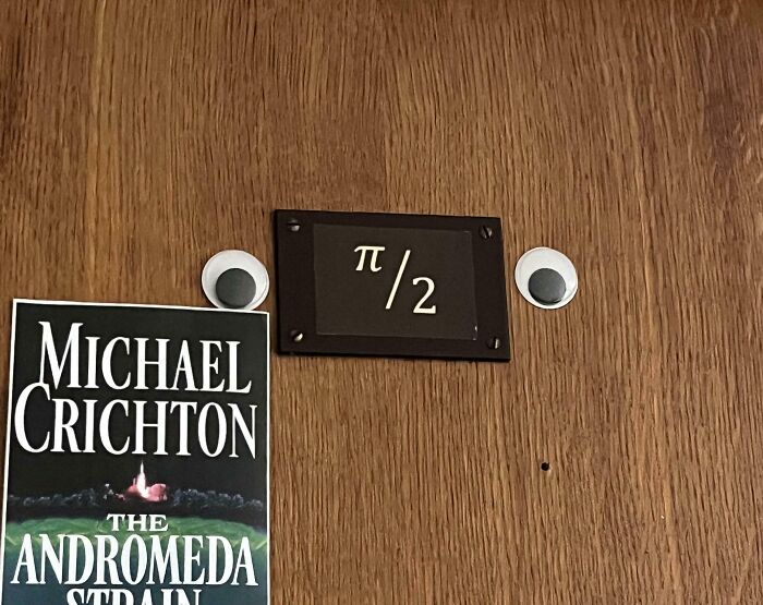 Door with pi over 2 sign and googly eyes for math humor on campus