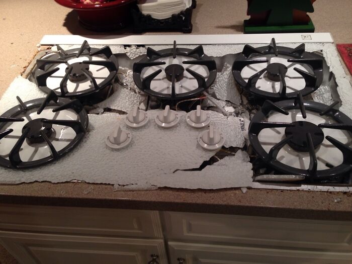 Gas stove with melted and broken burner grates kitchen cooking fail