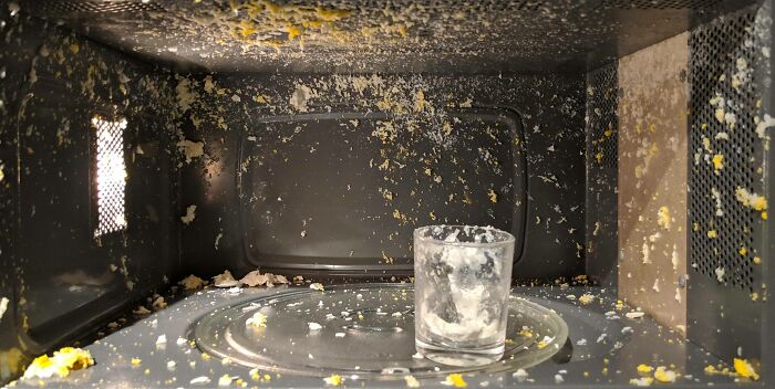 Microwave interior covered in splattered food kitchen fails mess