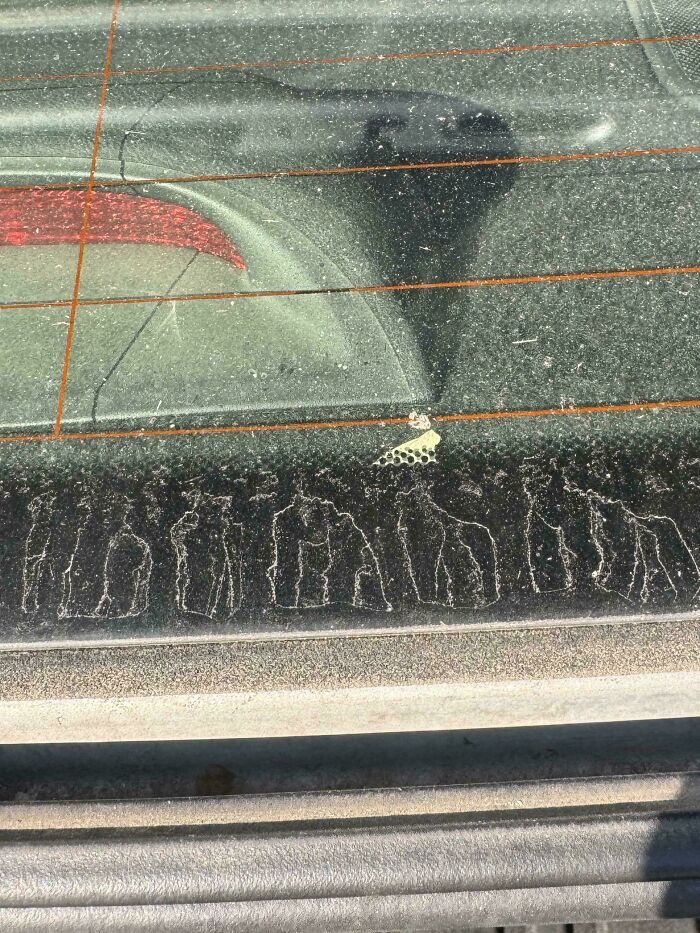 Dust pattern on car window resembling people shapes showing pareidolia effect