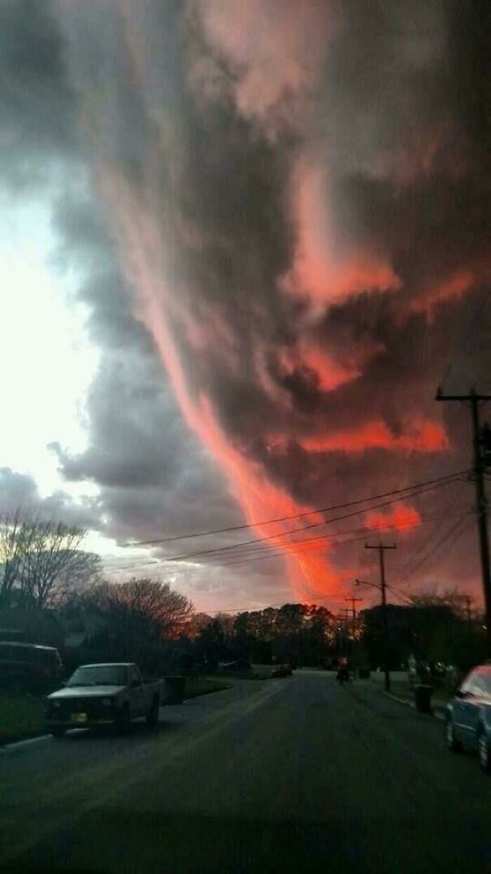 Sunset clouds form a scary face over the road pareidolia