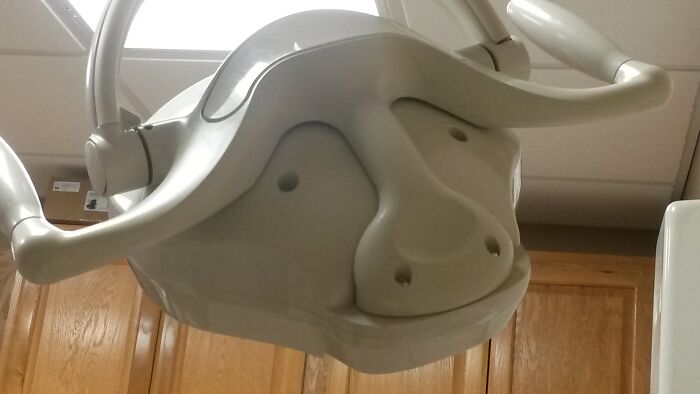 Dental light fixture looks like a smiling dog face pareidolia