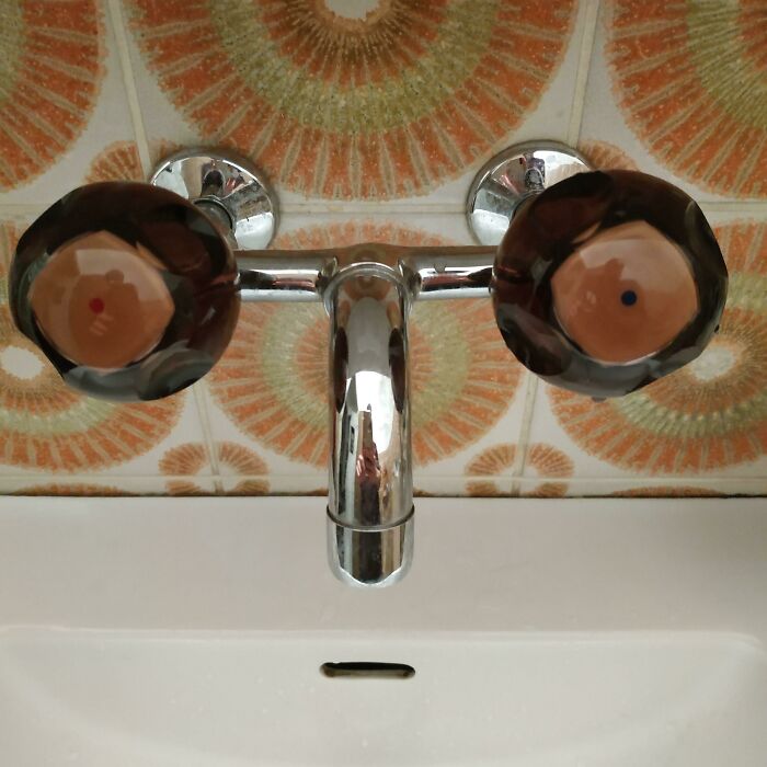 Bathroom faucet knobs resembling cartoon eyes face pareidolia
