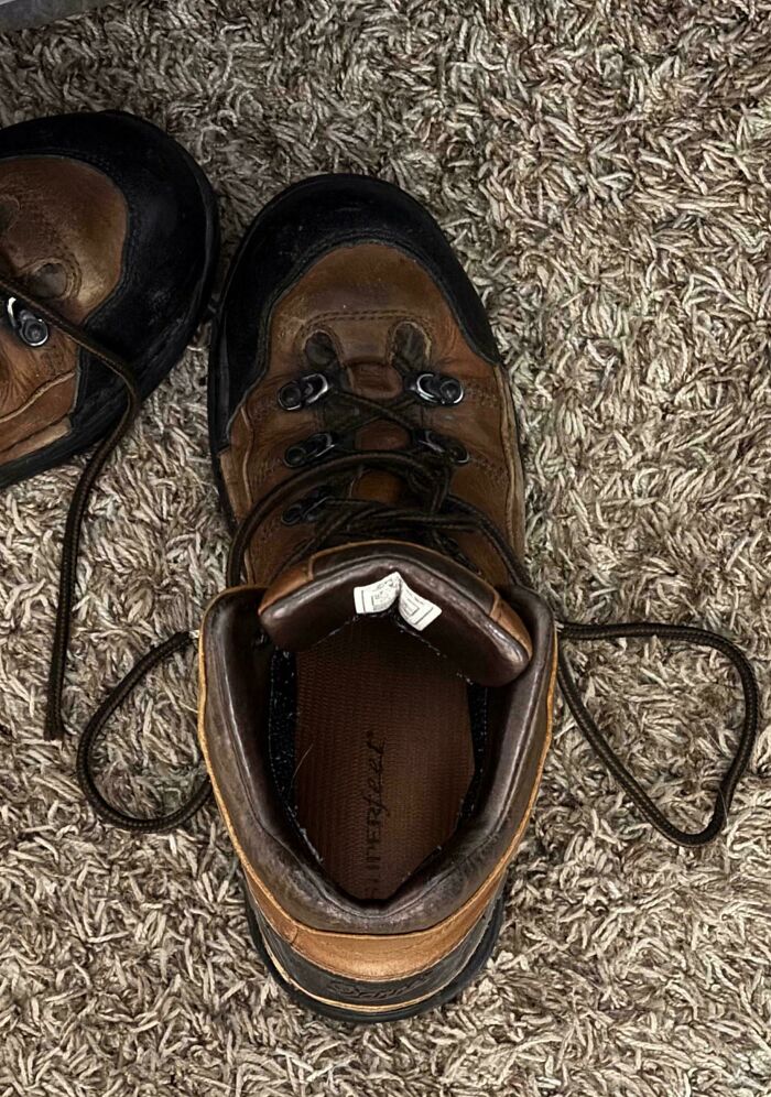 Pair of boots on carpet resembling a sad face pareidolia