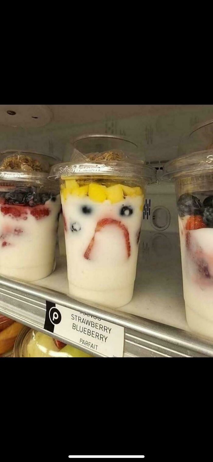 Yogurt parfait with fruit pieces arranged to resemble a sad face pareidolia