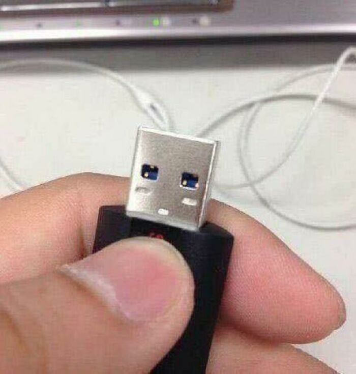 USB plug with holes resembling a surprised face pareidolia