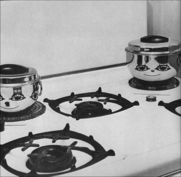 Reflective pots on stove with faces due to pareidolia