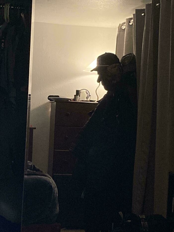 Shadow of person in dark room creating pareidolia effect