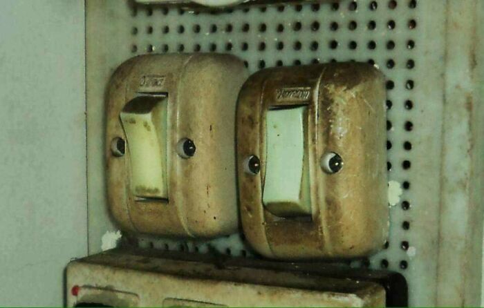 Old light switches resembling faces with eyes demonstrating pareidolia
