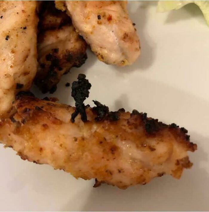 Charred chicken wing shaped like a running man with pareidolia