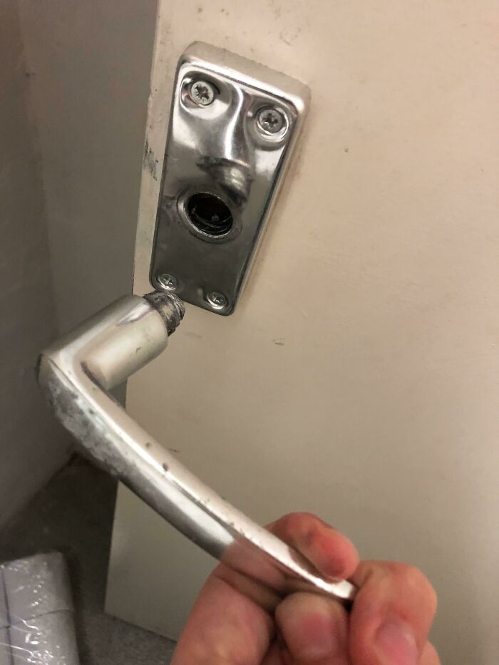 Broken door handle and plate resembling a surprised face with eyes