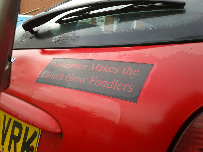 Funny British sign on red car with abstinence message about church growth