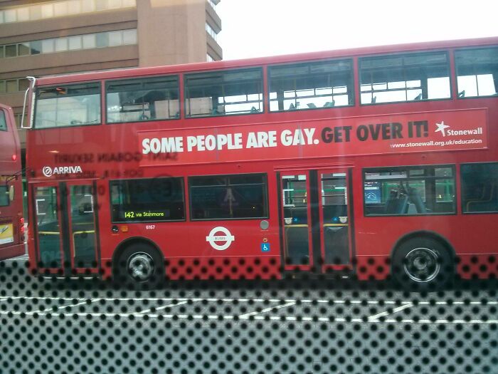 Red London bus with message some people are gay get over it
