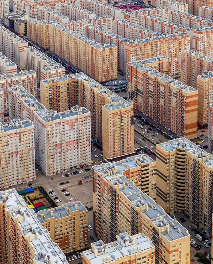 Aerial view of dense urban hell with repetitive high-rise apartment buildings