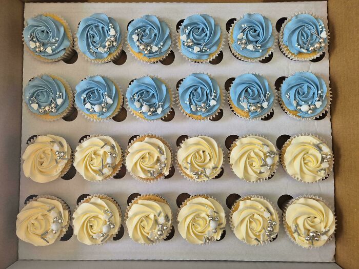 Box of cupcakes with blue and white rose frosting and edible pearls dessert