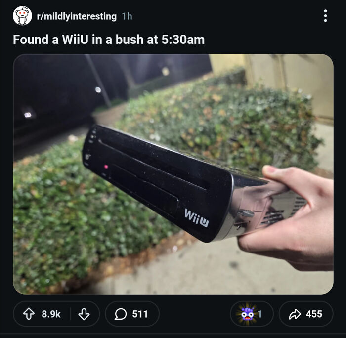 Person holding found WiiU gaming console outdoors