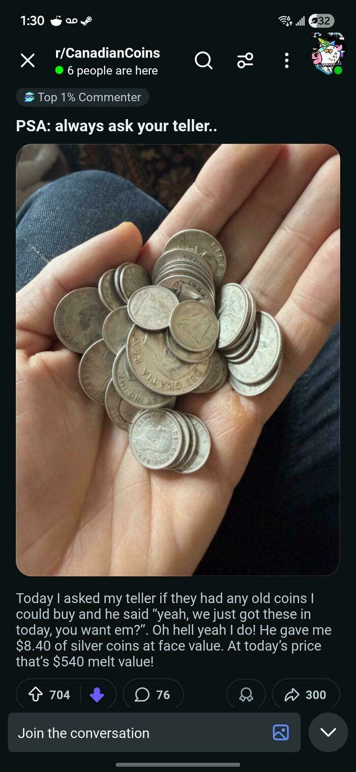 Hand holding collection of old silver Canadian coins with melt value