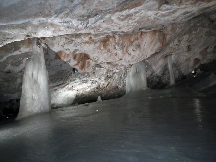 Ice formations inside a cave with textured ceiling stunning ice cave views