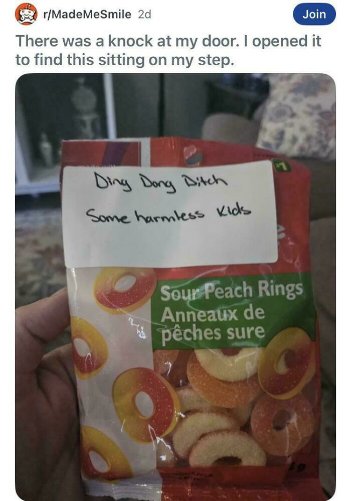 Hand holding sour peach rings candy with humorous label fake internet points