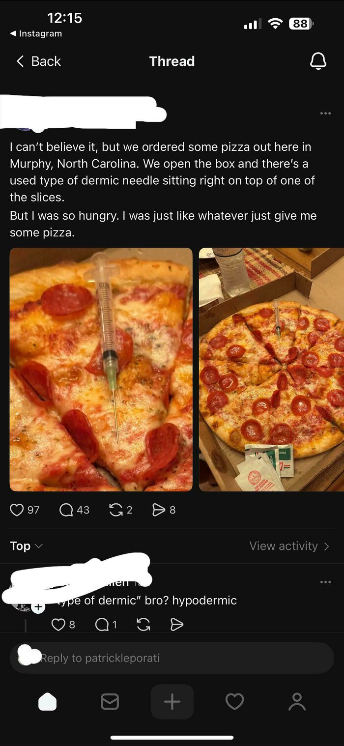 Pizza box with a hypodermic needle stuck in one slice