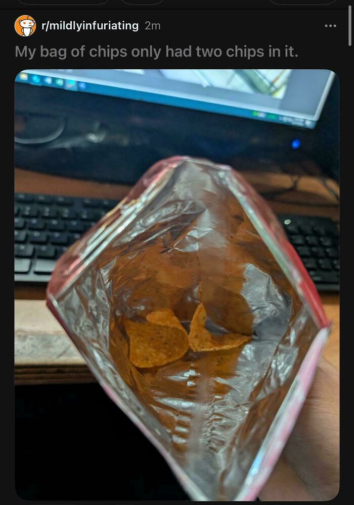 Open bag of chips containing only two chips inside
