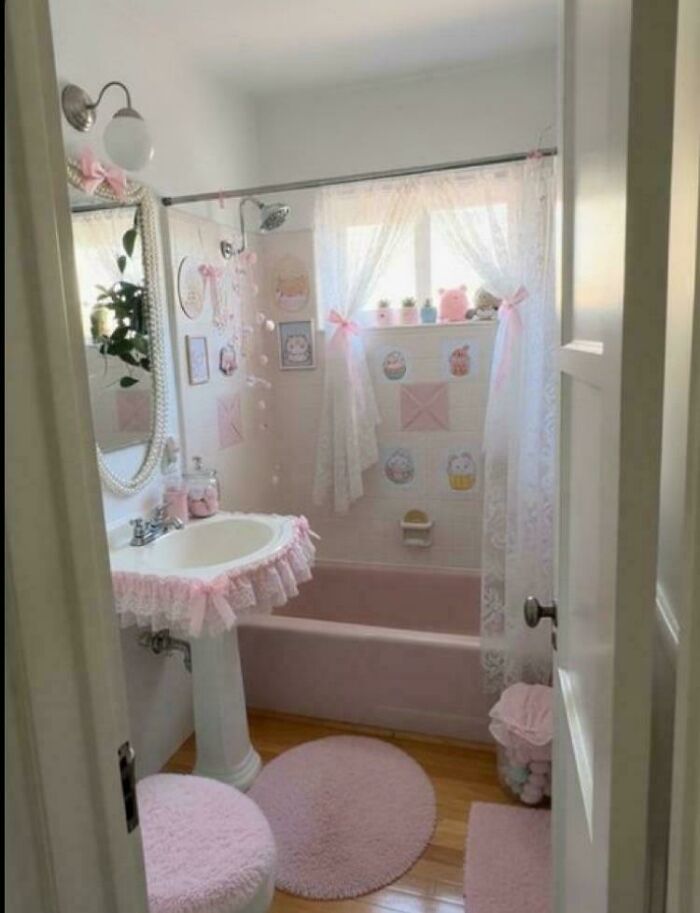 Pink-themed small bathroom with plush accessories illustrating cleaning challenges