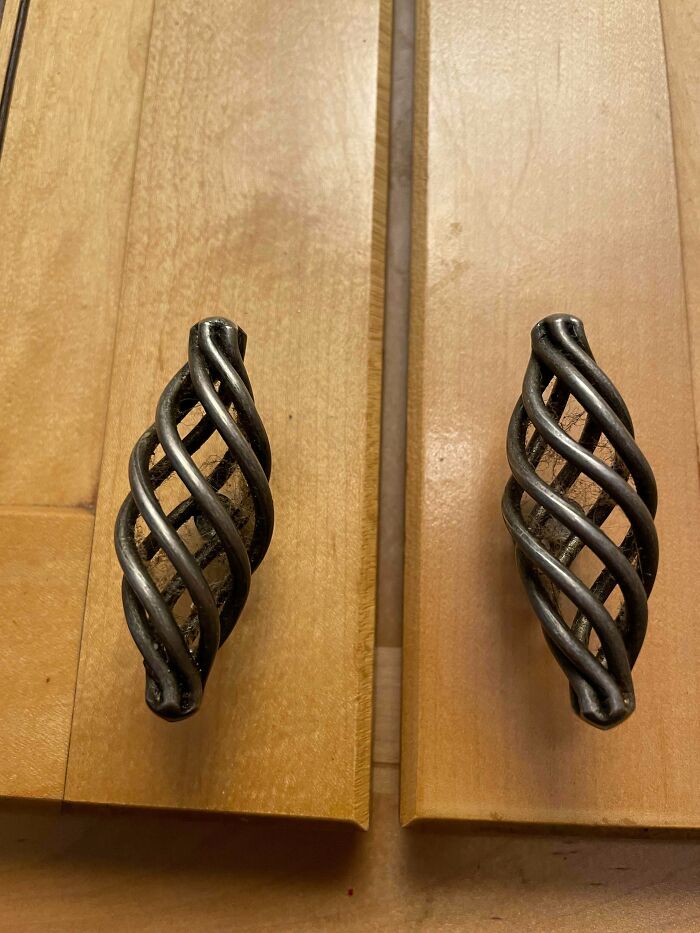 Dusty cabinet handles show designers forgot cleaning