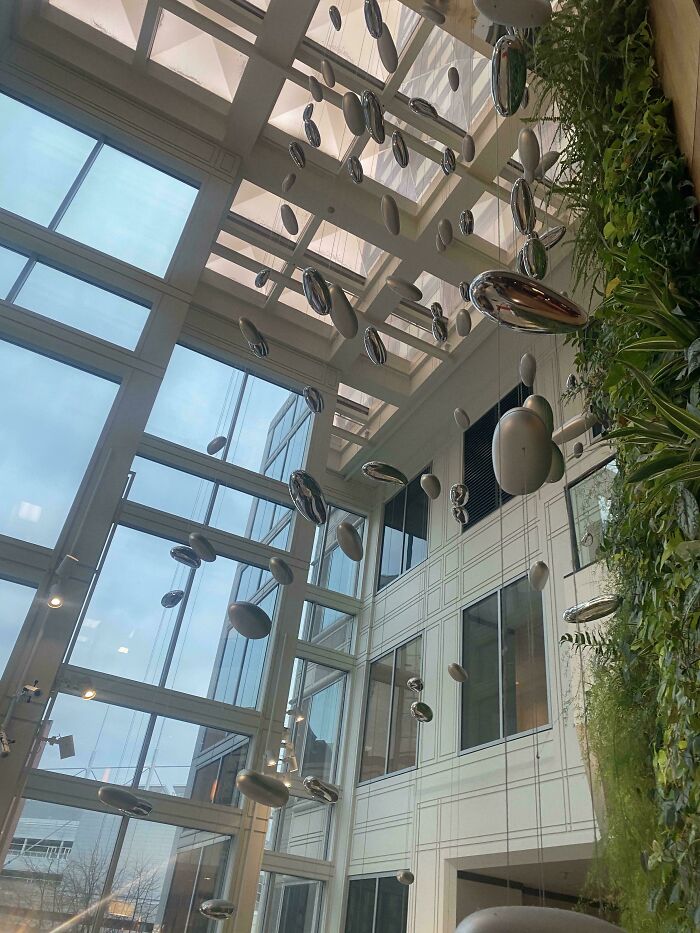 Modern atrium with hanging silver mobile installation