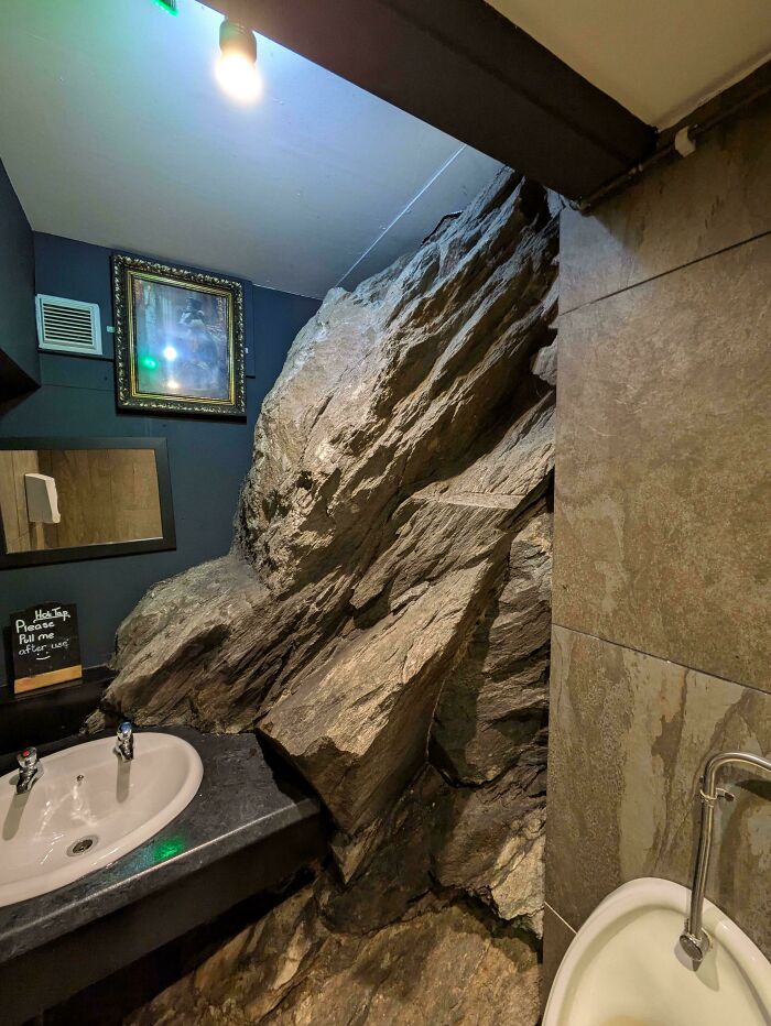 Bathroom with large rock integrated into the sink area