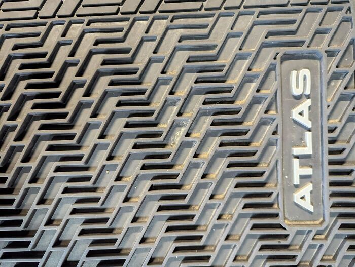 Car mat design featuring confusing non-slip pattern with word Atlas