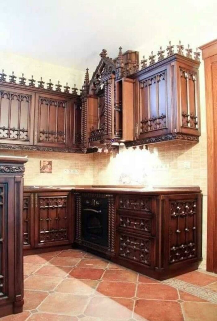 Ornate wooden kitchen cabinets with intricate Gothic design