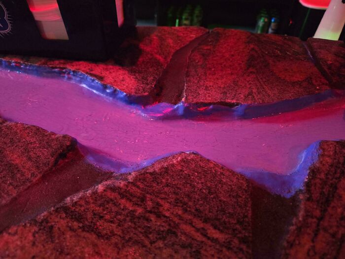 Bar countertop with built-in poorly done blue resin river design