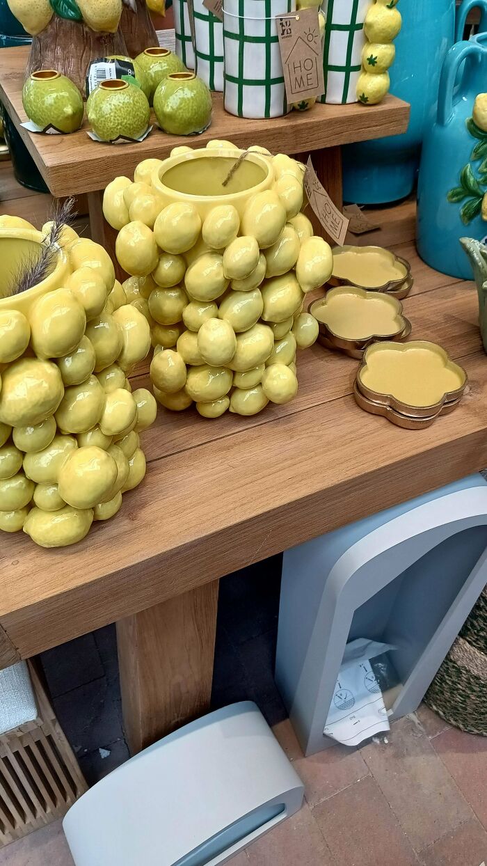 Yellow ceramic vase covered with round protrusions on shelf