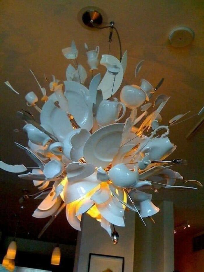 Chandelier made of broken white ceramic dishes and utensils