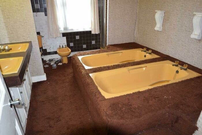 Bathroom with carpeted bathtub and brown carpet floor design