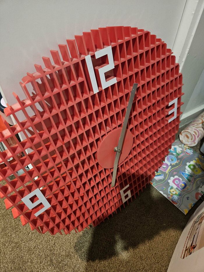 Red grid clock with confusing number placement on face