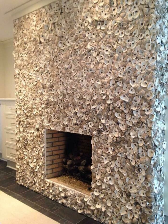 Fireplace wall decorated with oyster shells creating unique texture