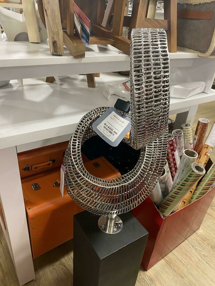 Modern metal sculpture on pedestal with tag price