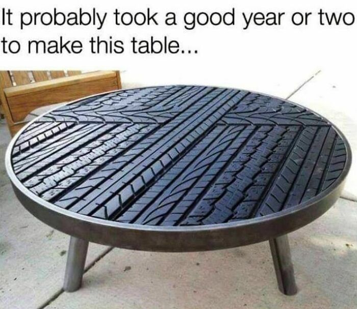 Round coffee table with black tire tread surface highlighting creative design