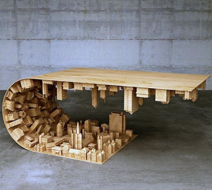 Wooden coffee table designed with an upside-down cityscape and wave form base